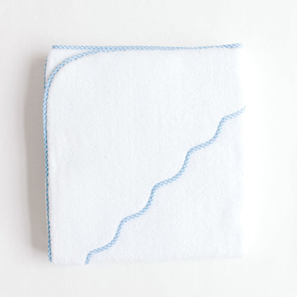 White towel with blue trim on a light gray background