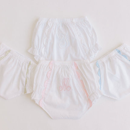 Set of white diaper covers with colorful accents on a light gray background