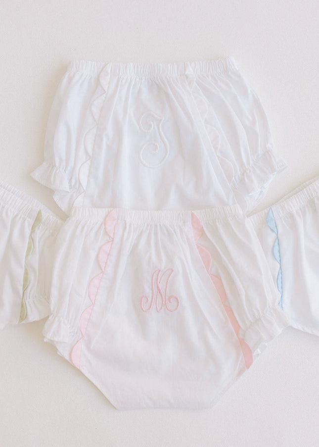 Set of white diaper covers with colorful accents on a light gray background