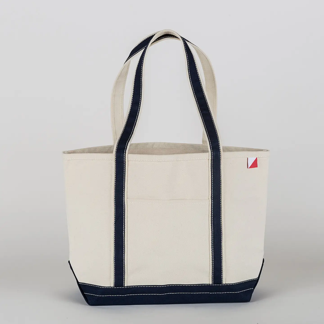 Natural tote bag with navy accents on a light gray background
